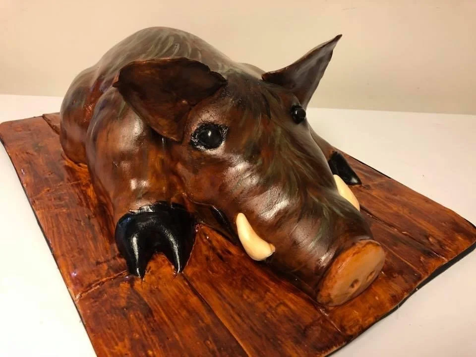 Sculpted wild boar cake designed as a realistic wildlife-themed animal cake.