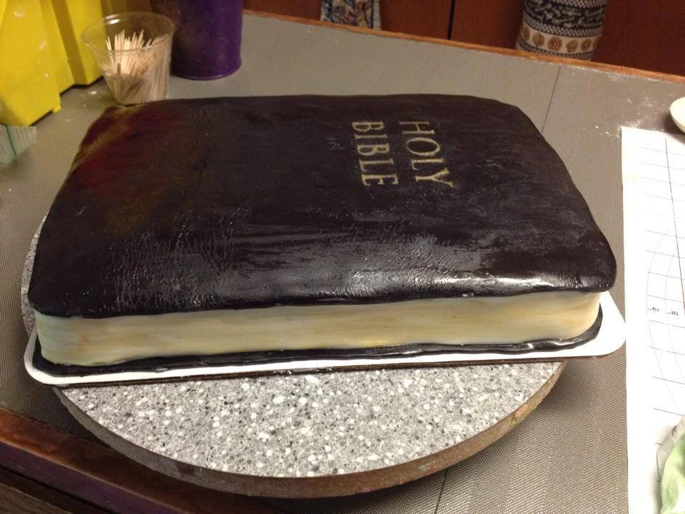 Sculpted Bible cake with gold edged pages and embossed cross detail