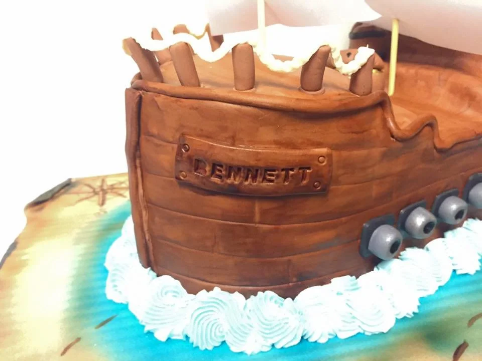 Three dimensional pirate ship cake with sails and wood texture