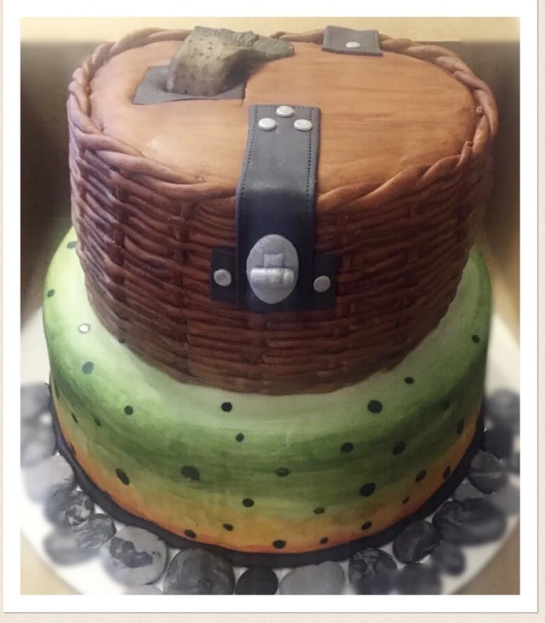 fishing creel cake with rainbow trout pattern and fish sticking out top