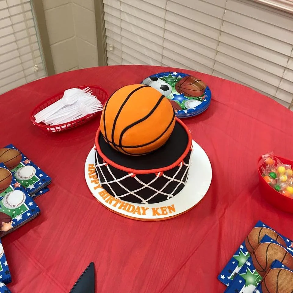 Gravity defying basketball cake going through edible hoop and net