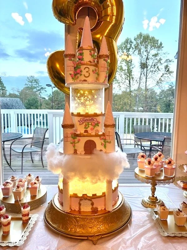 Tiered castle cake with towers for princess birthday celebration
