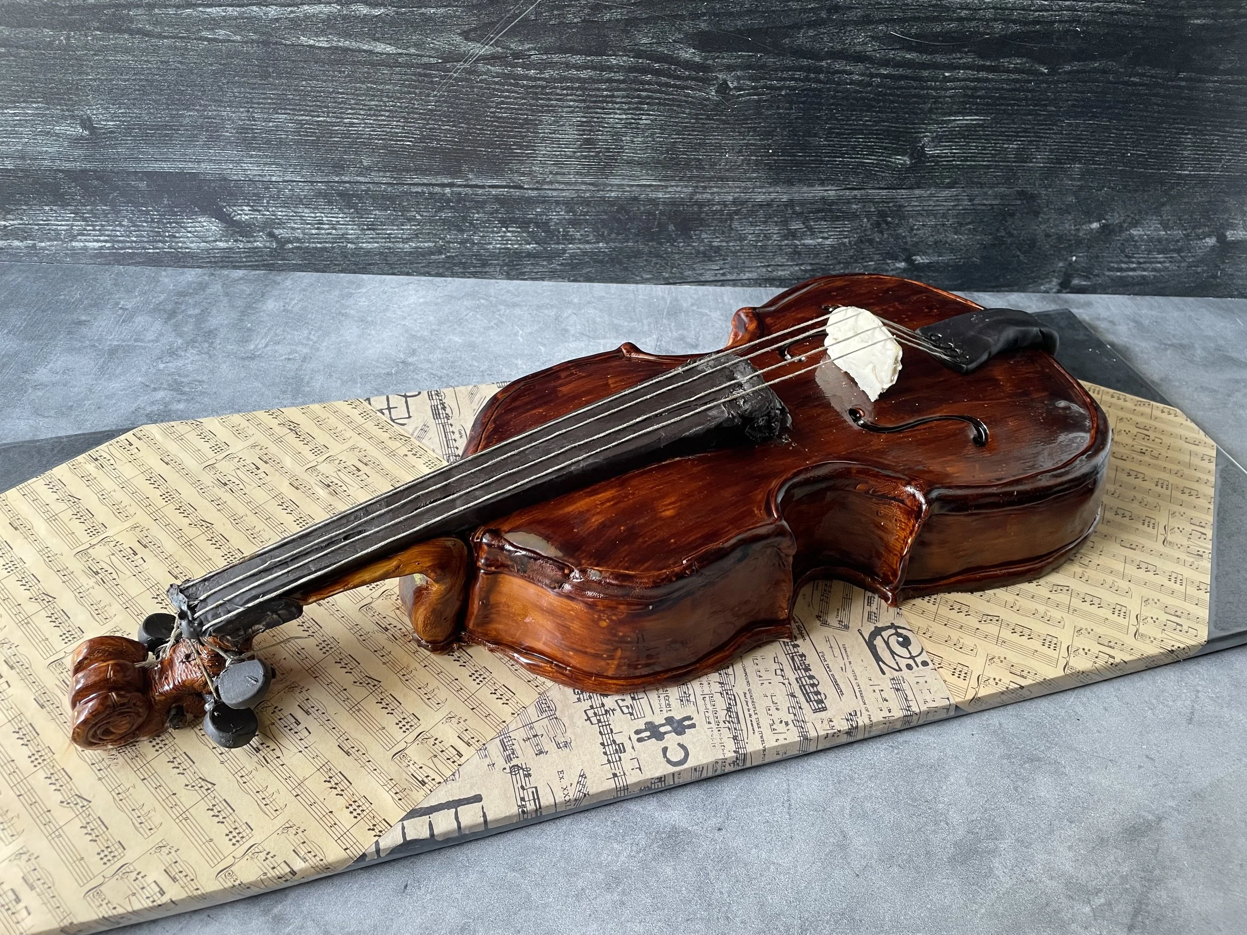 Realistic violin cake designed to capture the elegant shape and wood tones of a violin.