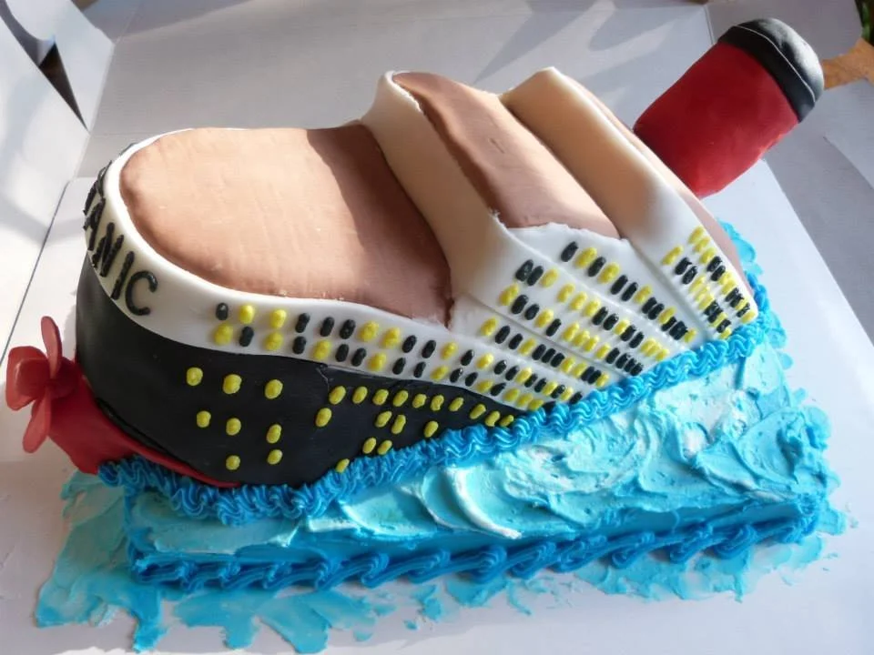 Sculpted Titanic ship cake designed for themed event