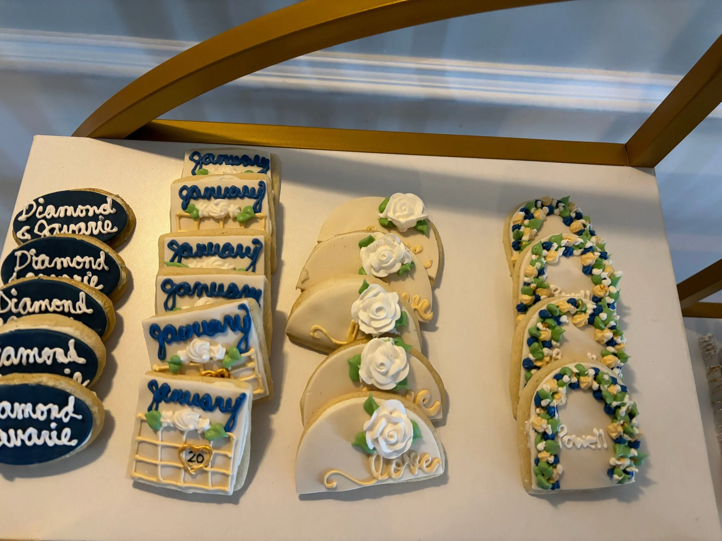 Decorated sugar cookies with different designs, including one set with