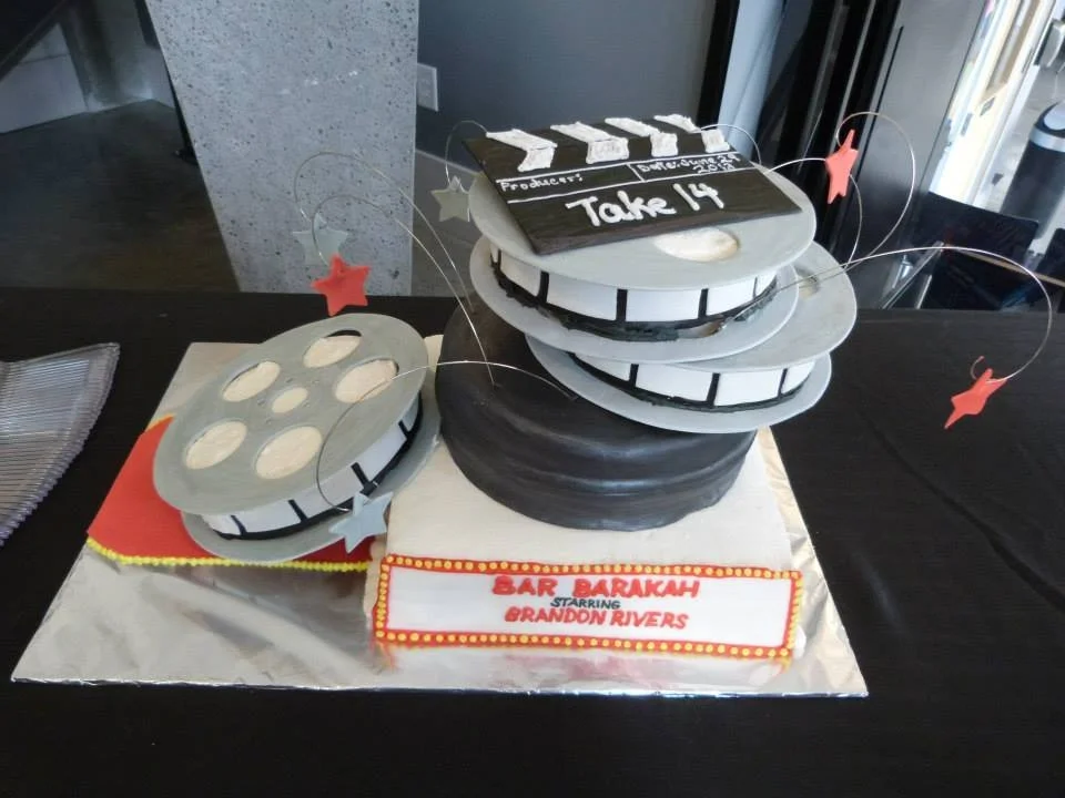 Stacked film reel and canister cake for movie themed event