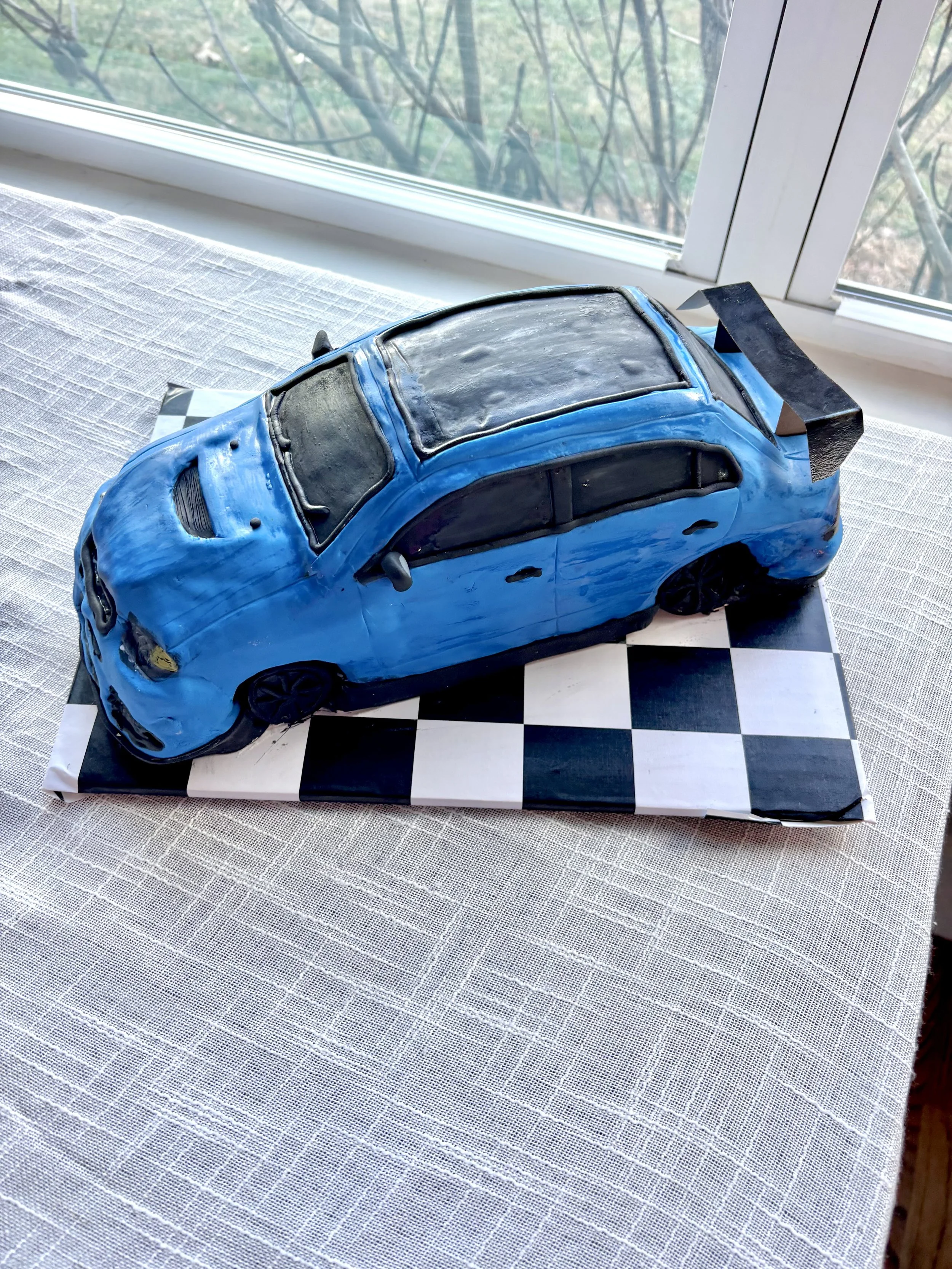 Mitsubishi Lancer Evolution sports car cake created for a groom’s cake celebration.