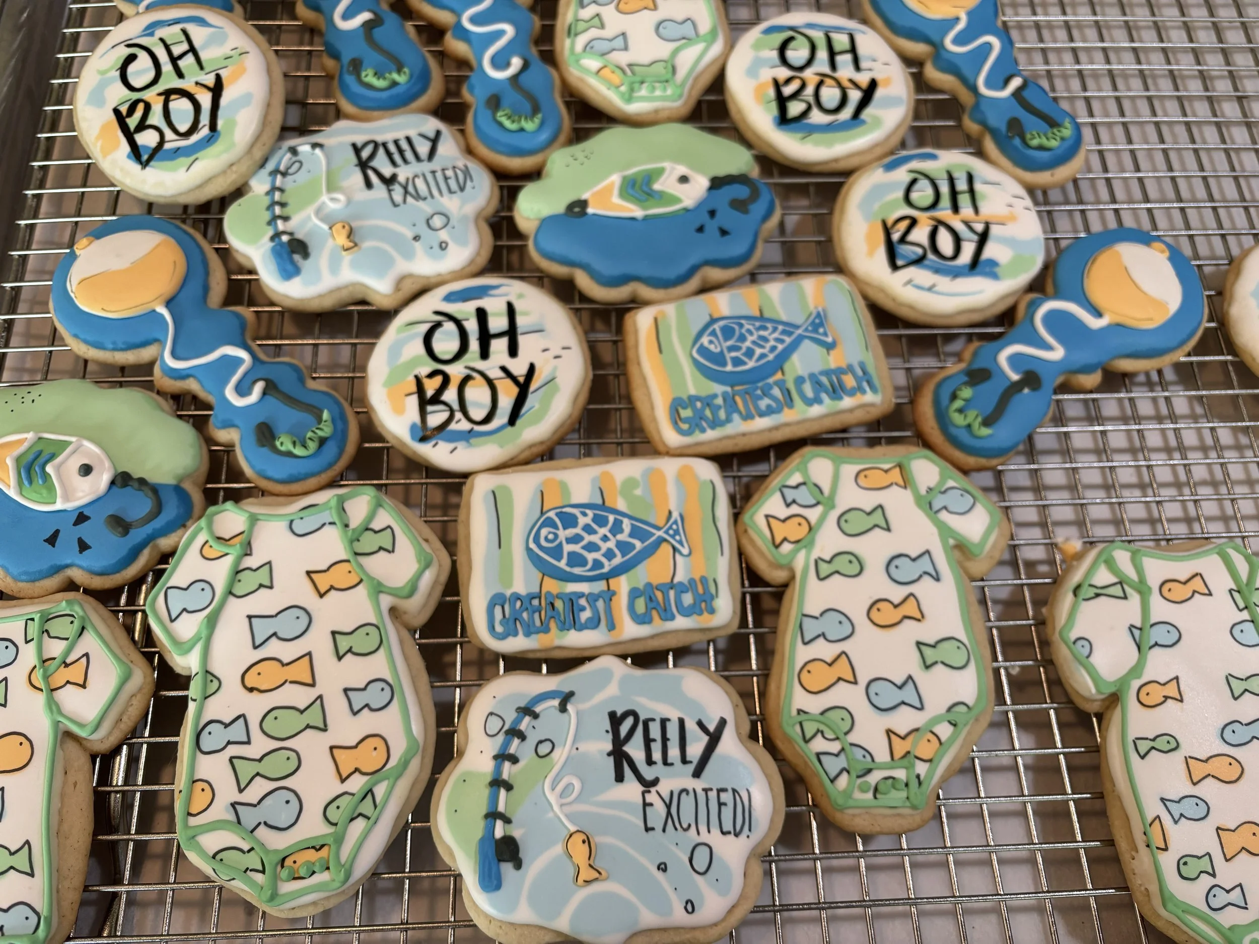Onesies, reely excited, oh boy, fishing bobber, greatest catch decorated sugar cookies