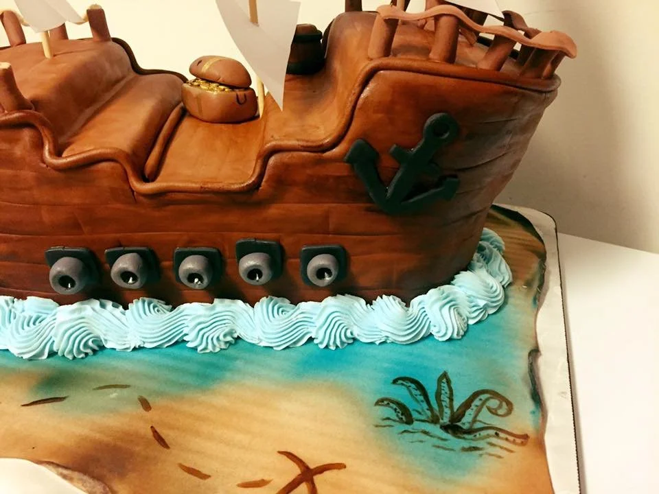 Three dimensional pirate ship cake with sails and wood texture