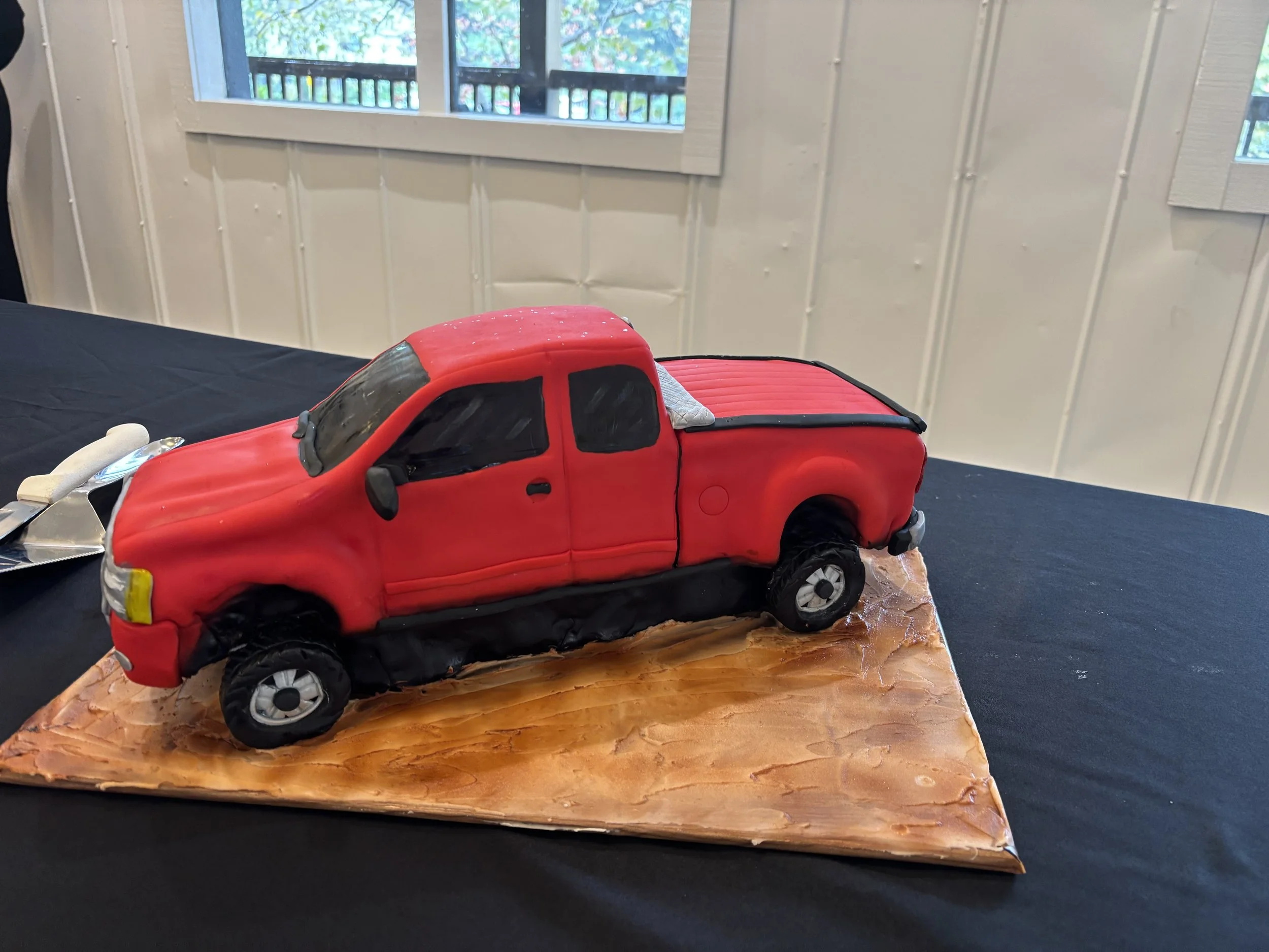 Red Chevrolet Silverado pickup truck cake designed as a groom’s cake for a truck enthusiast.