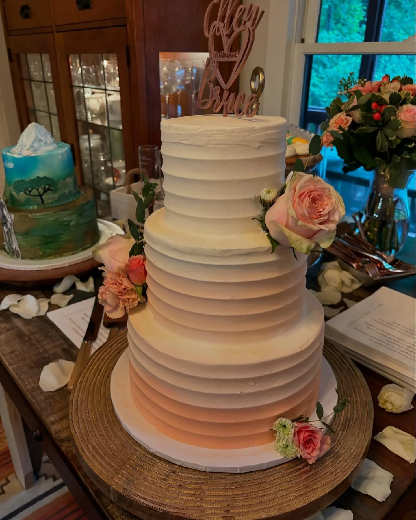 Three tiered ombre peach and white wedding cake with fresh flower accents.jpg