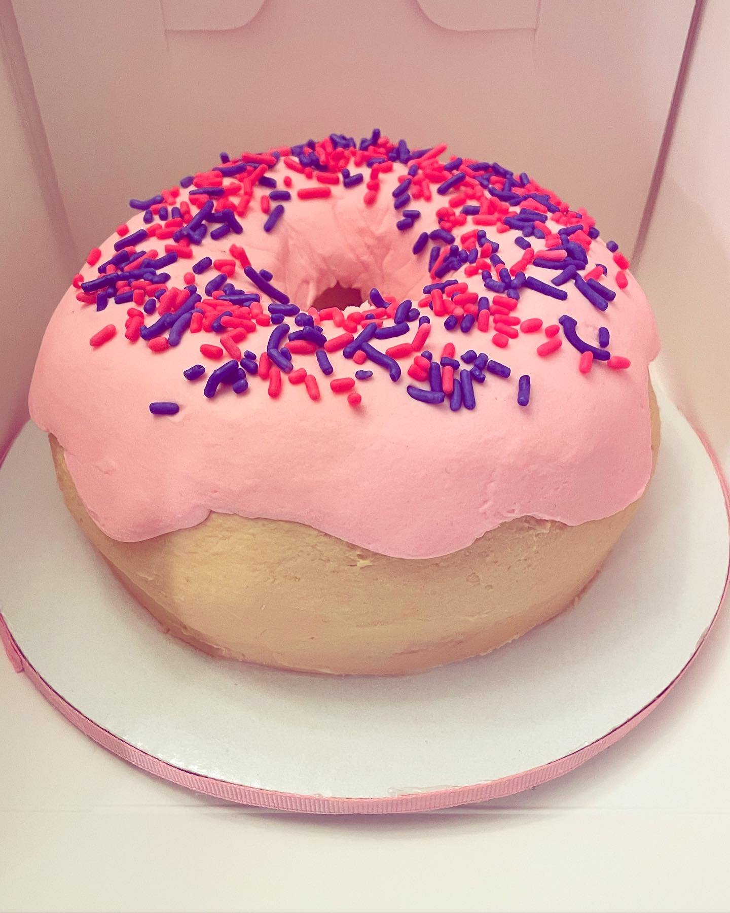 Oversized sculpted donut cake with realistic glaze and sprinkles