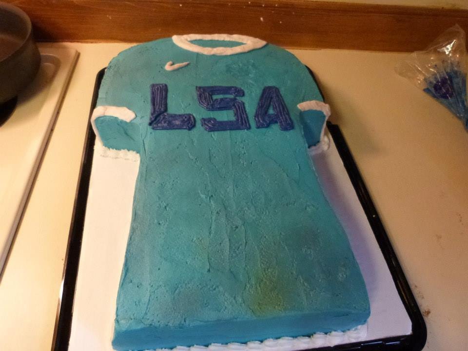 Custom sculpted soccer jersey cake for athlete celebration