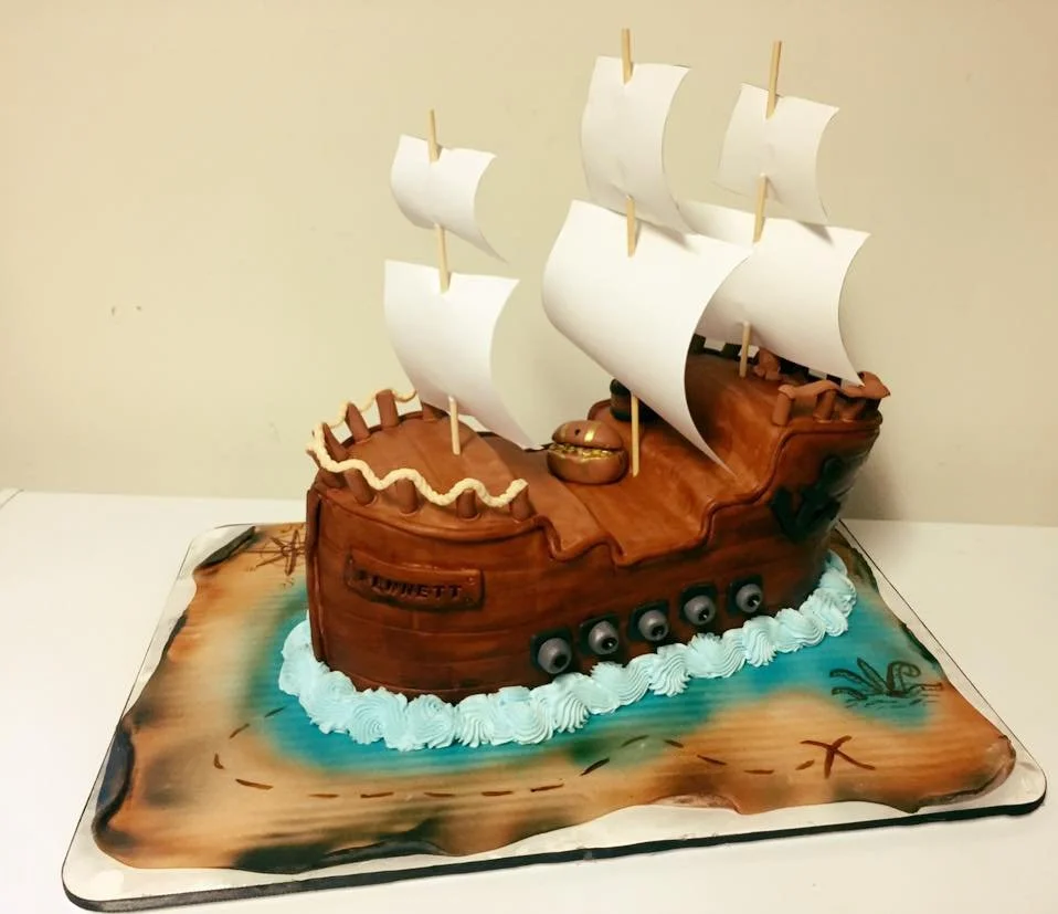 Three dimensional pirate ship cake with sails and wood texture