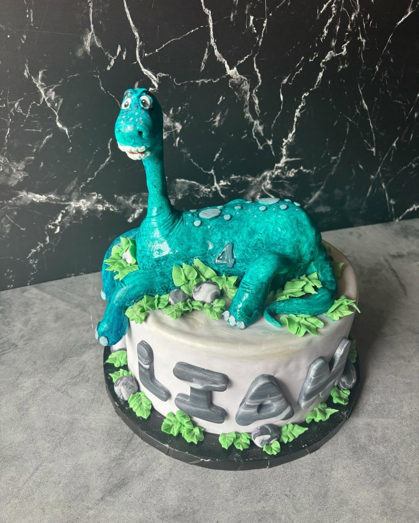 Sculpted diplodocus dinosaur birthday cake designed in North Georgia