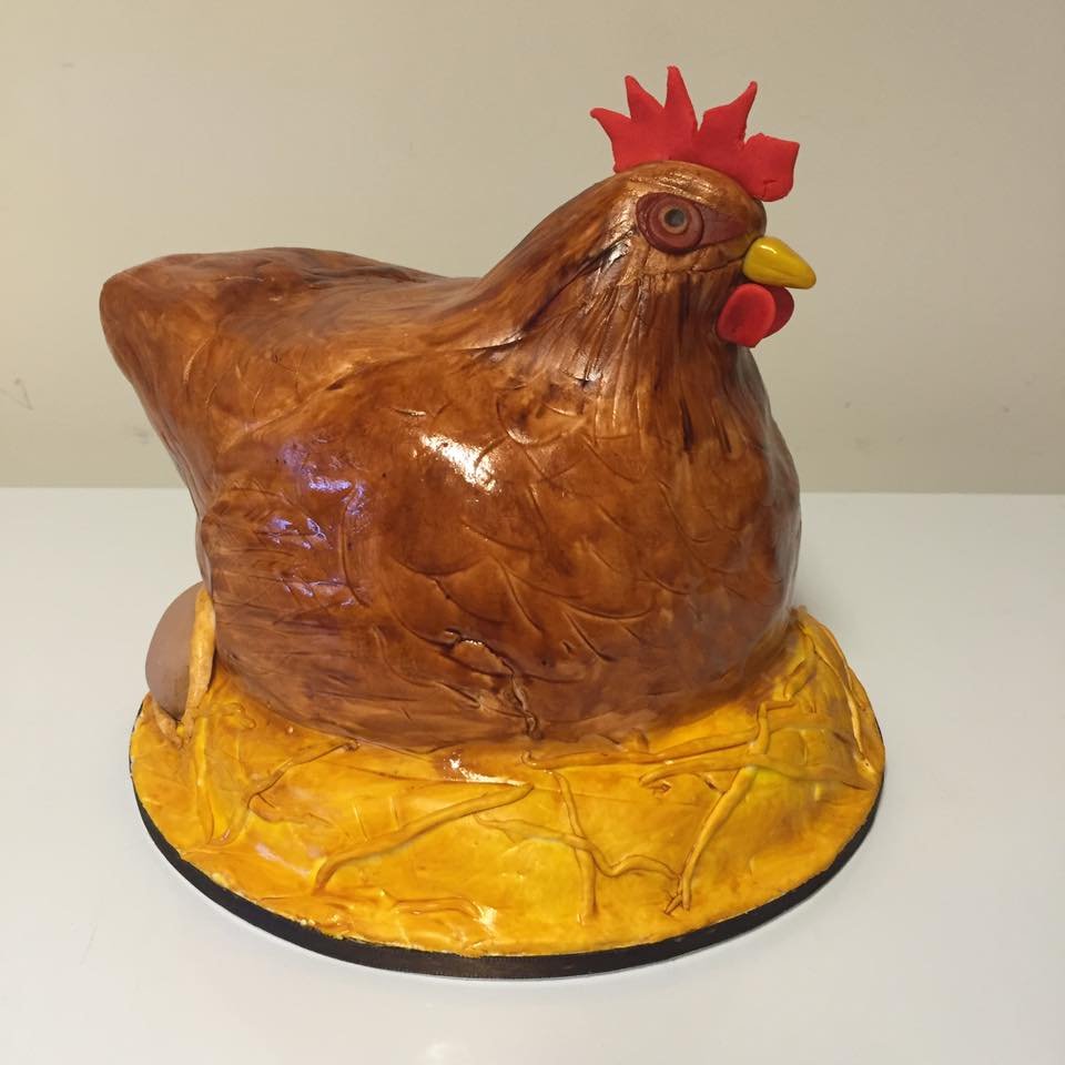 Cake designed to resemble porcelain chicken figurine with painted details