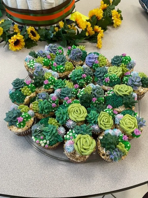 Buttercream succulent cupcakes arranged for garden themed celebration