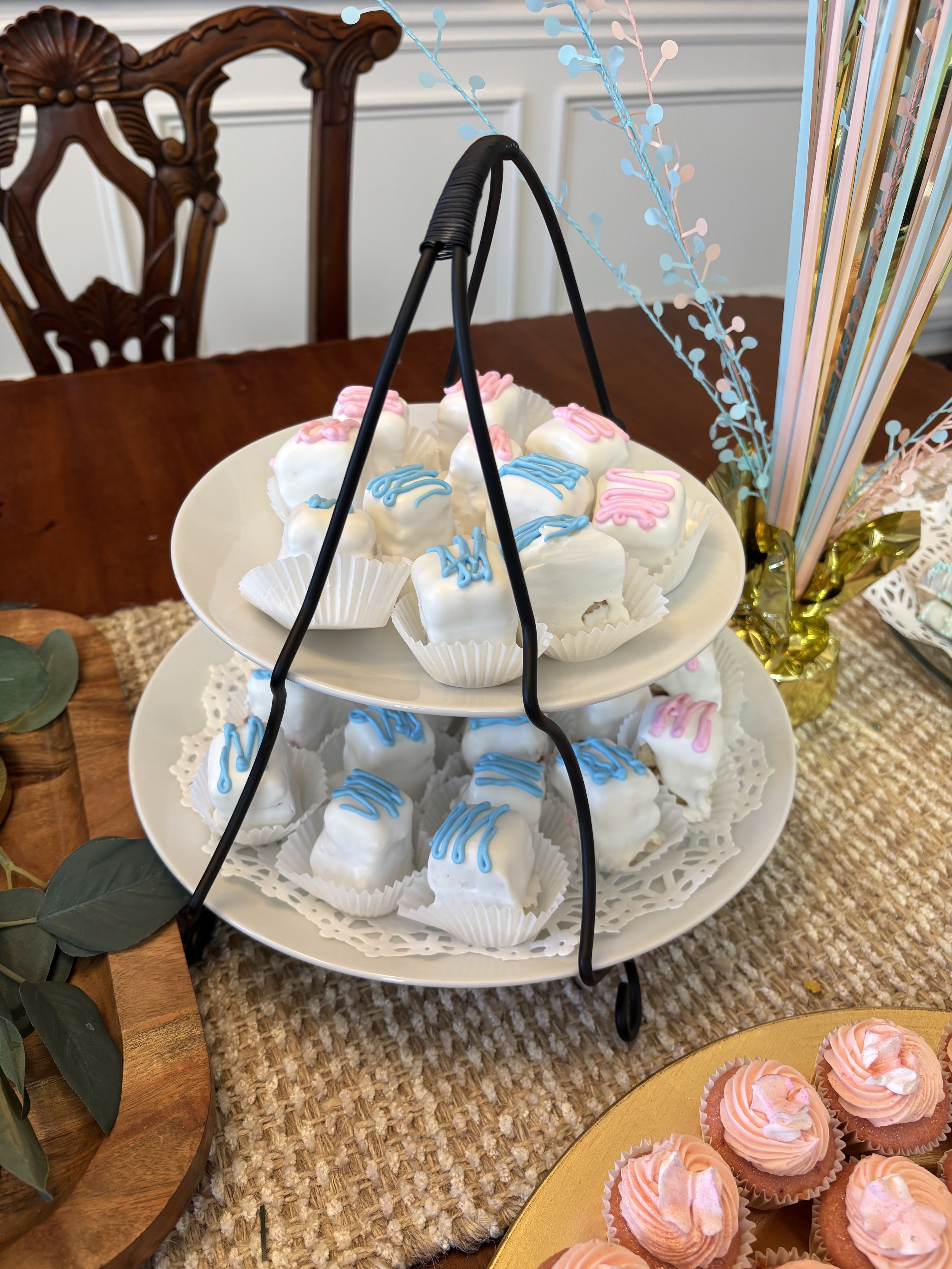 Handmade petit fours in blue and pink for a gender reveal party