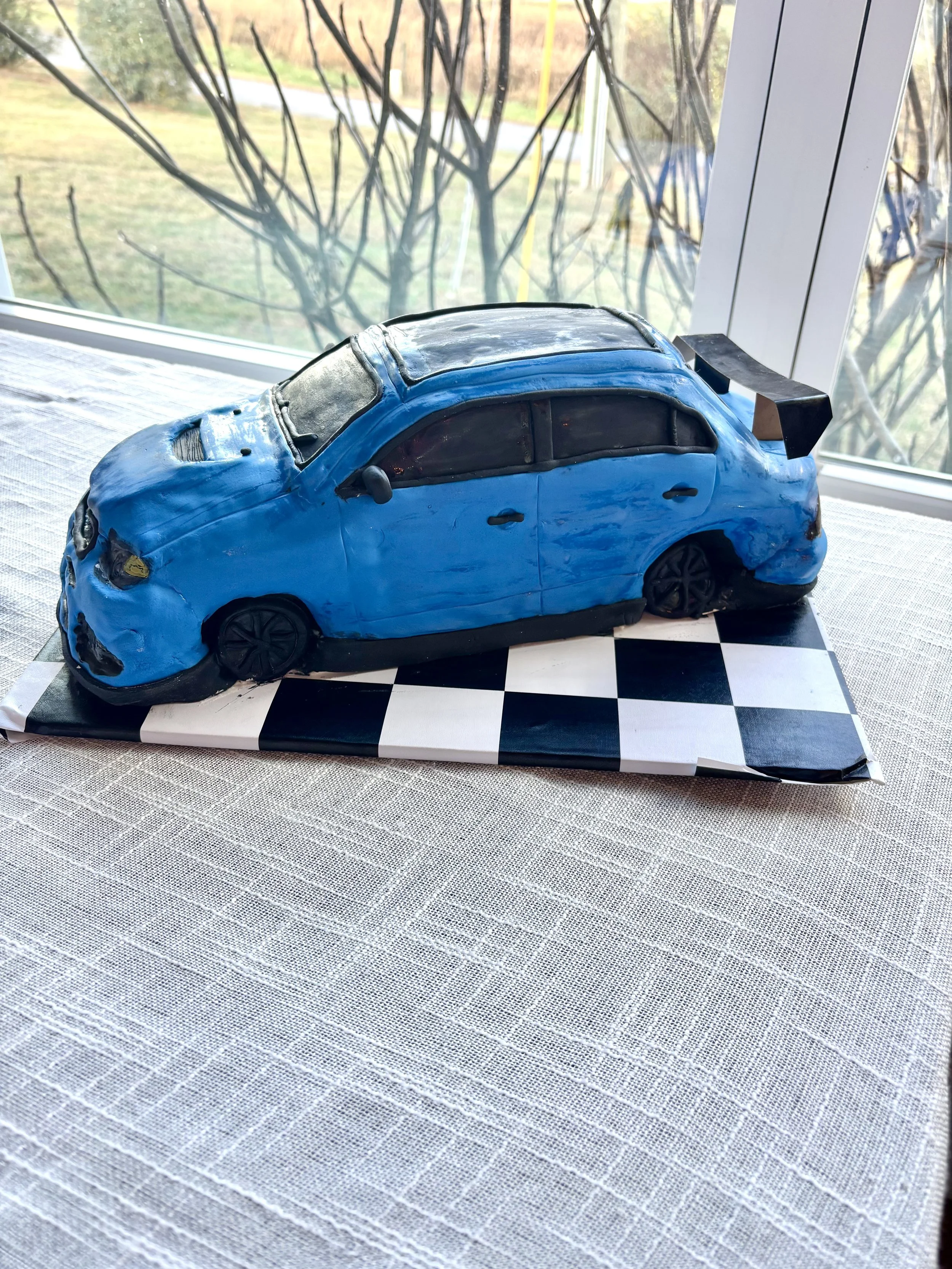 Mitsubishi Lancer Evolution sports car cake created for a groom’s cake celebration.