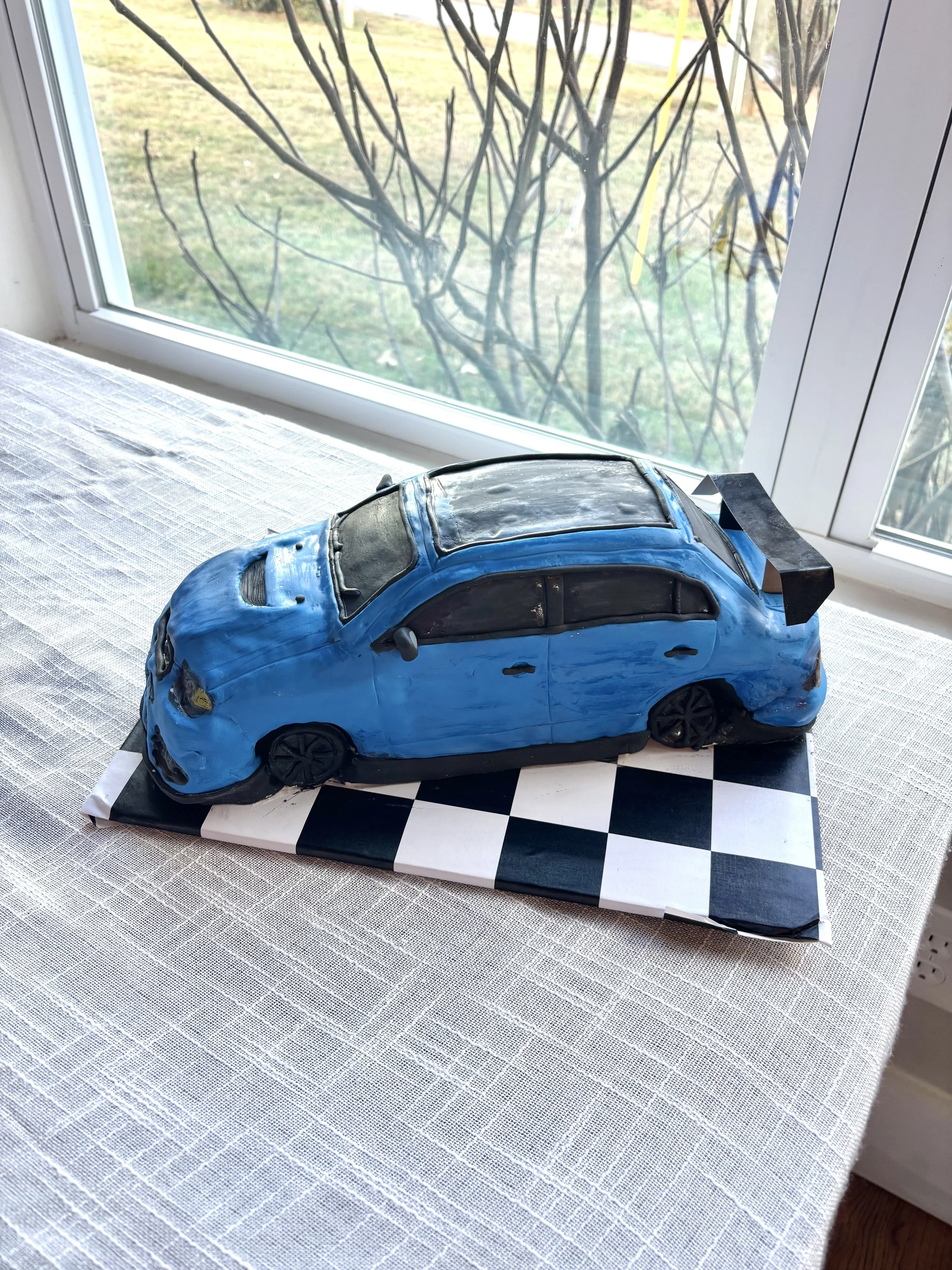 Mitsubishi Lancer Evolution sports car cake created for a groom’s cake celebration.