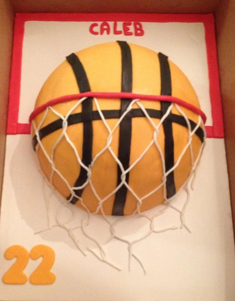 Round basketball cake with edible hoop and net for sports celebration