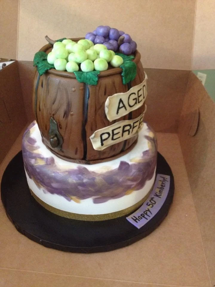 Rustic wine barrel cake with grapes and 'aged to perfection' design
