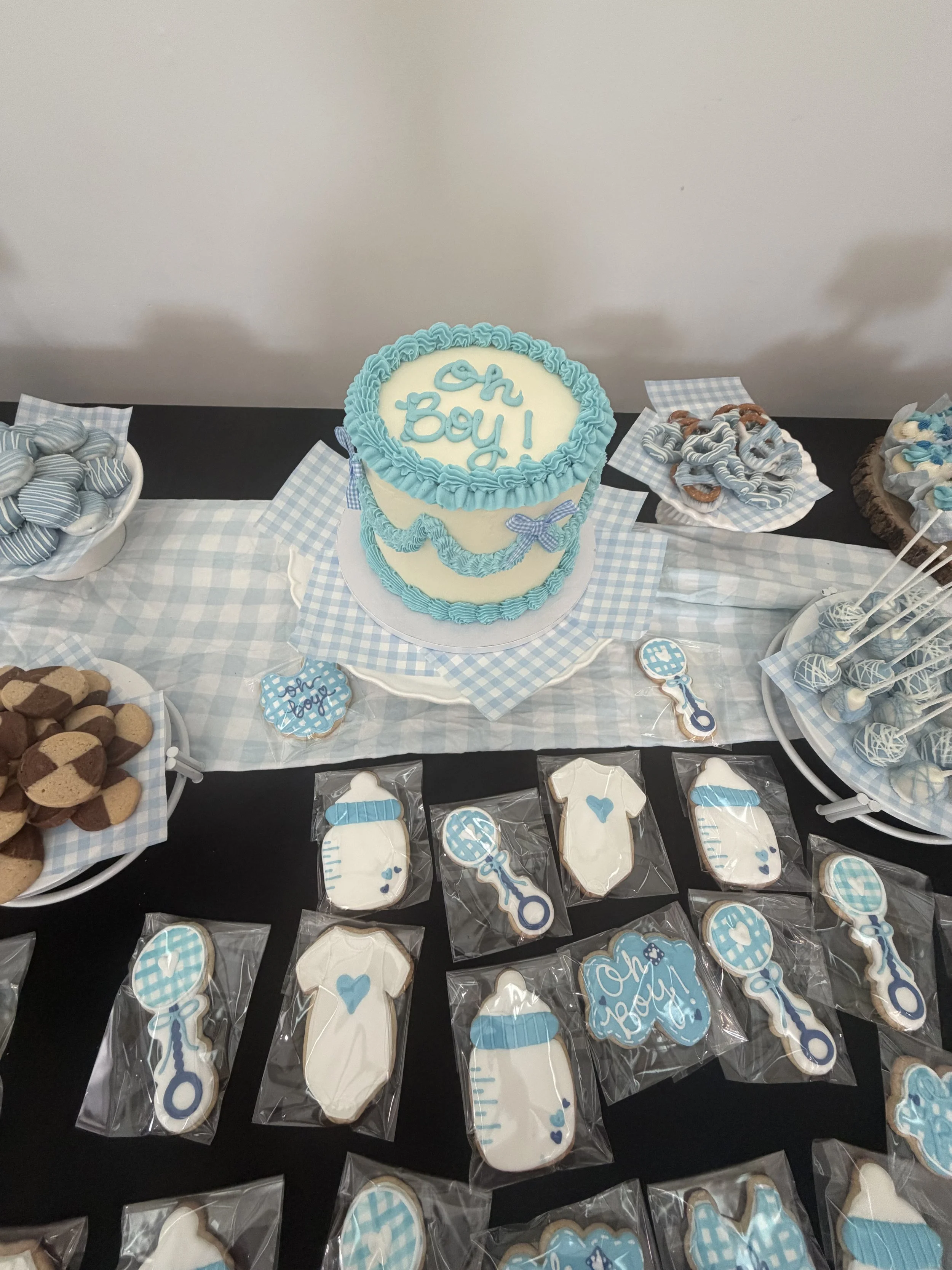 Centerpiece baby shower cake, decorated cookies for baby boy