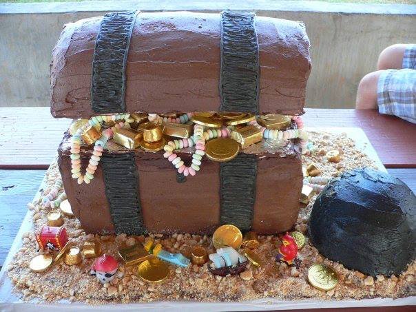 Three dimensional pirate treasure chest cake filled with edible gold coins and jewels