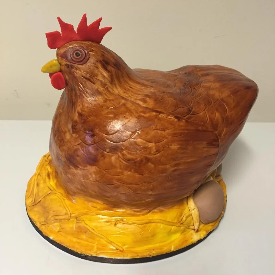 Cake designed to resemble porcelain chicken figurine with painted details