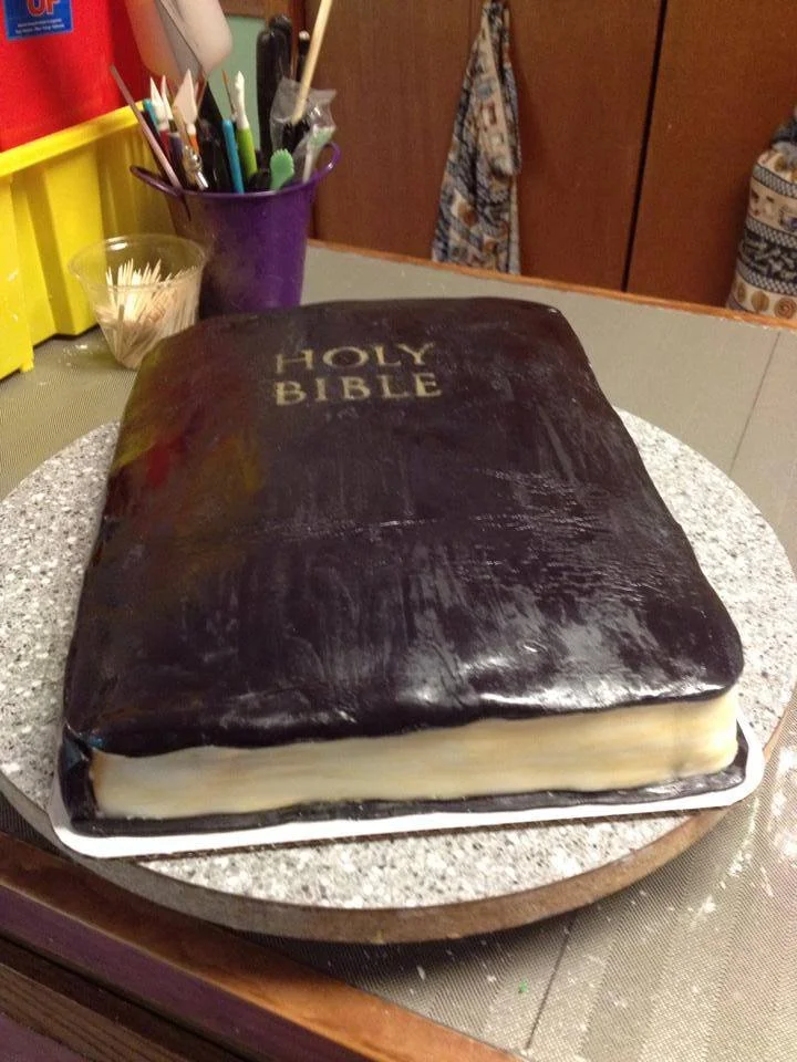 Sculpted Bible cake with gold edged pages and embossed cross detail