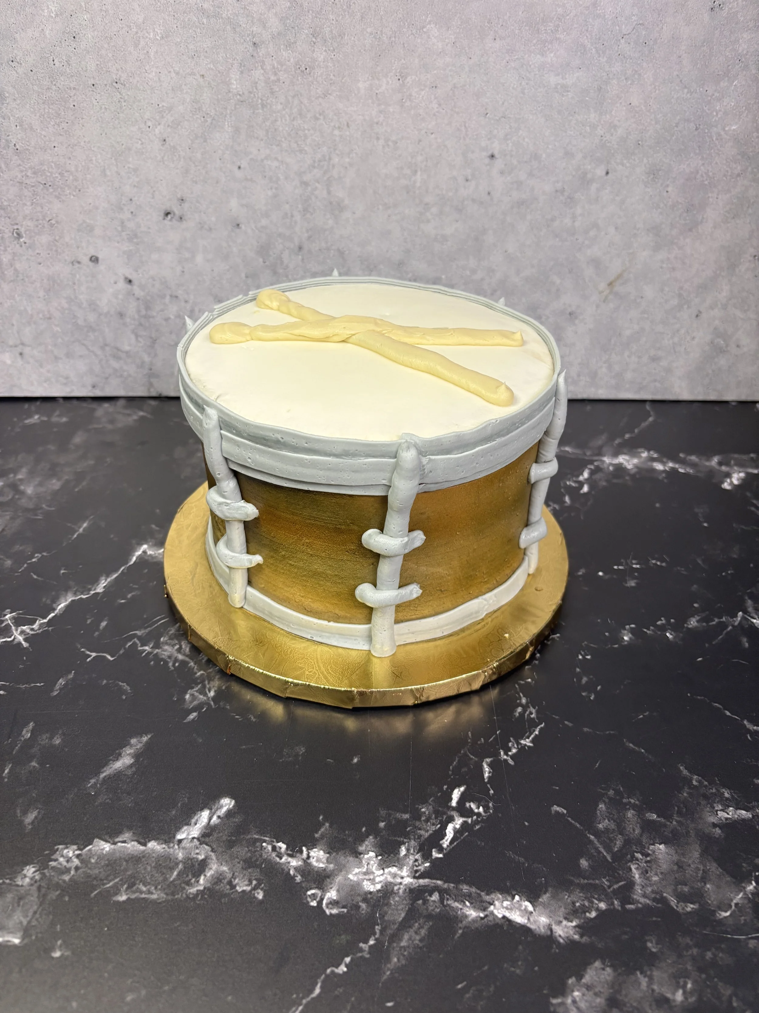 Sculpted drum cake designed for music-themed celebrations.