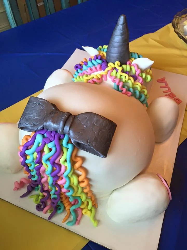 Colorful unicorn cake with rainbow mane and sculpted horn