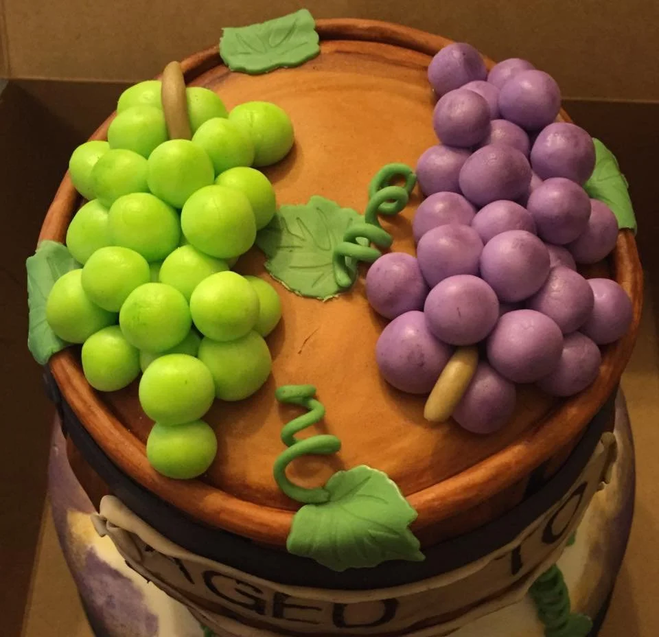 Rustic wine barrel cake with grapes and 'aged to perfection' design