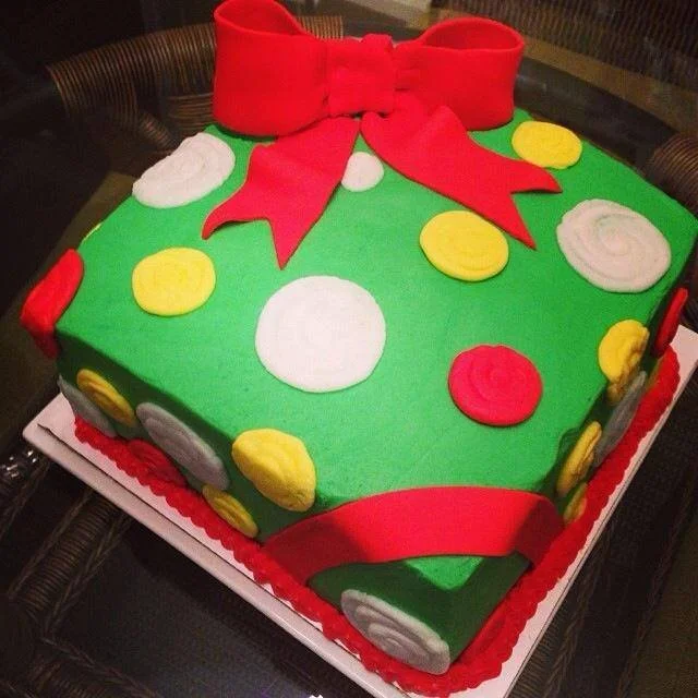 Sculpted gift box cake with detailed bow and fondant wrapping for celebration