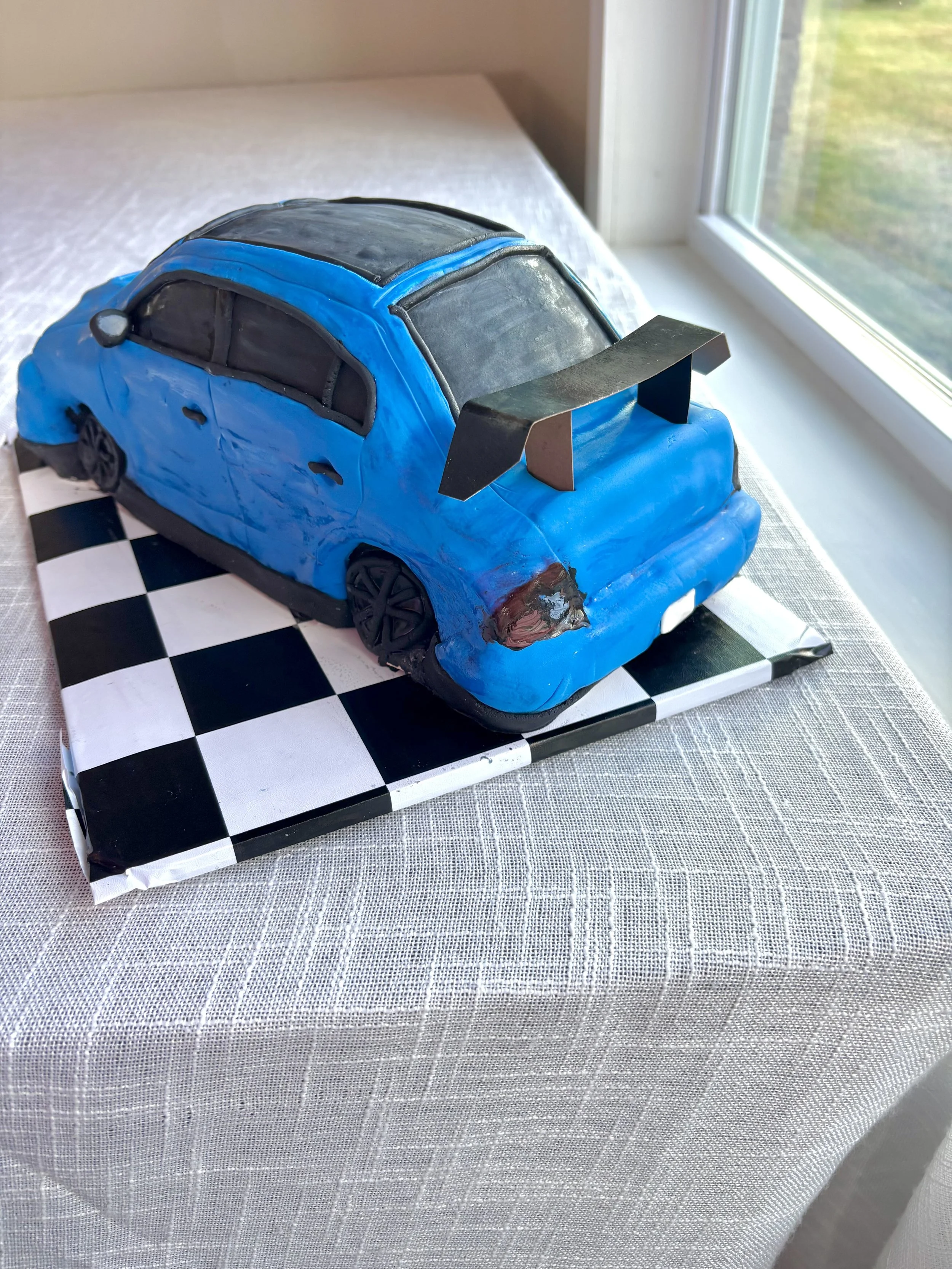 Mitsubishi Lancer Evolution sports car cake created for a groom’s cake celebration.