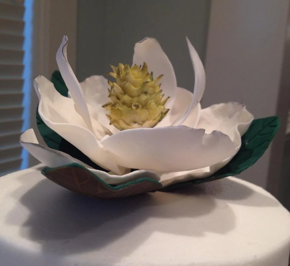 Handcrafted gum paste magnolia flower created for elegant cake design