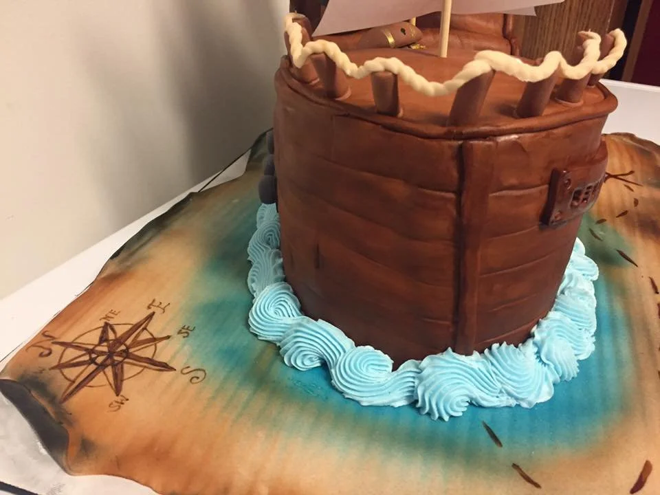 Three dimensional pirate ship cake with sails and wood texture