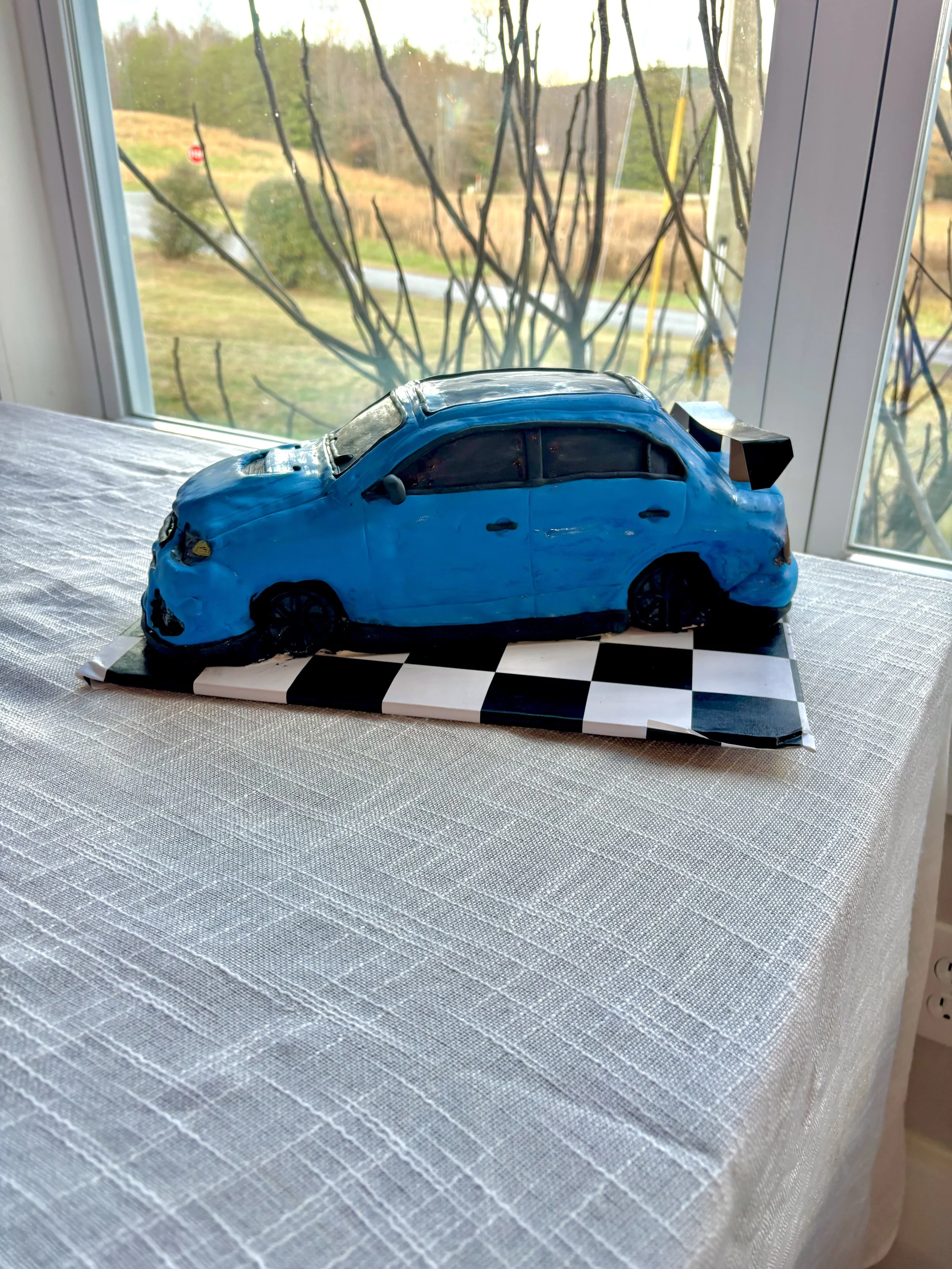 Mitsubishi Lancer Evolution sports car cake created for a groom’s cake celebration.