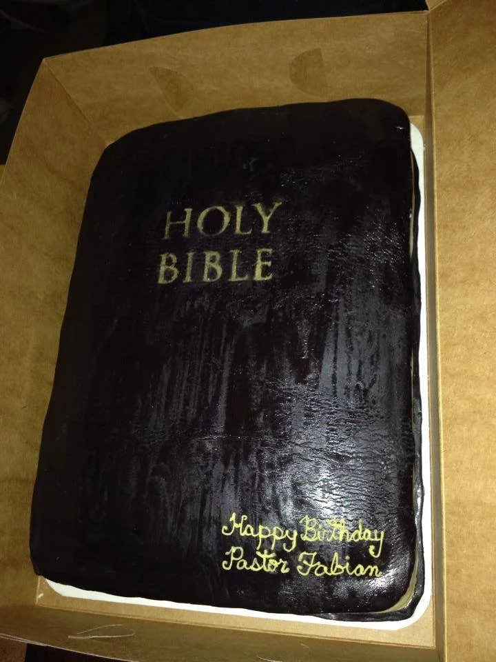 Sculpted Bible cake with gold edged pages and embossed cross detail
