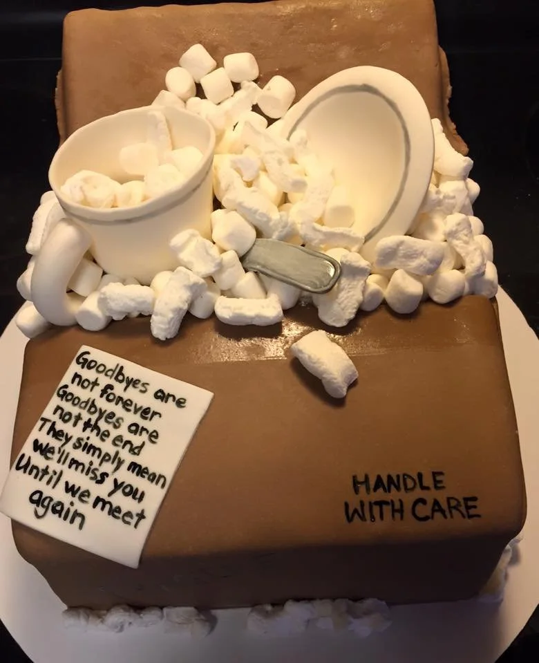 Sculpted moving box cake with packing peanuts and edible dishes inside