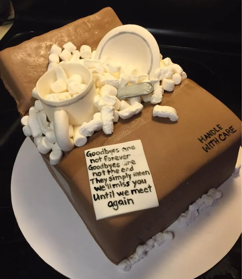 Sculpted moving box cake with packing peanuts and edible dishes inside