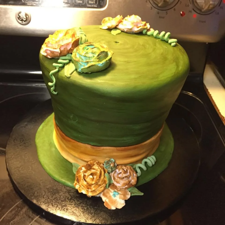 Whimsical top hat cake with flowers inspired by storybook tea party theme