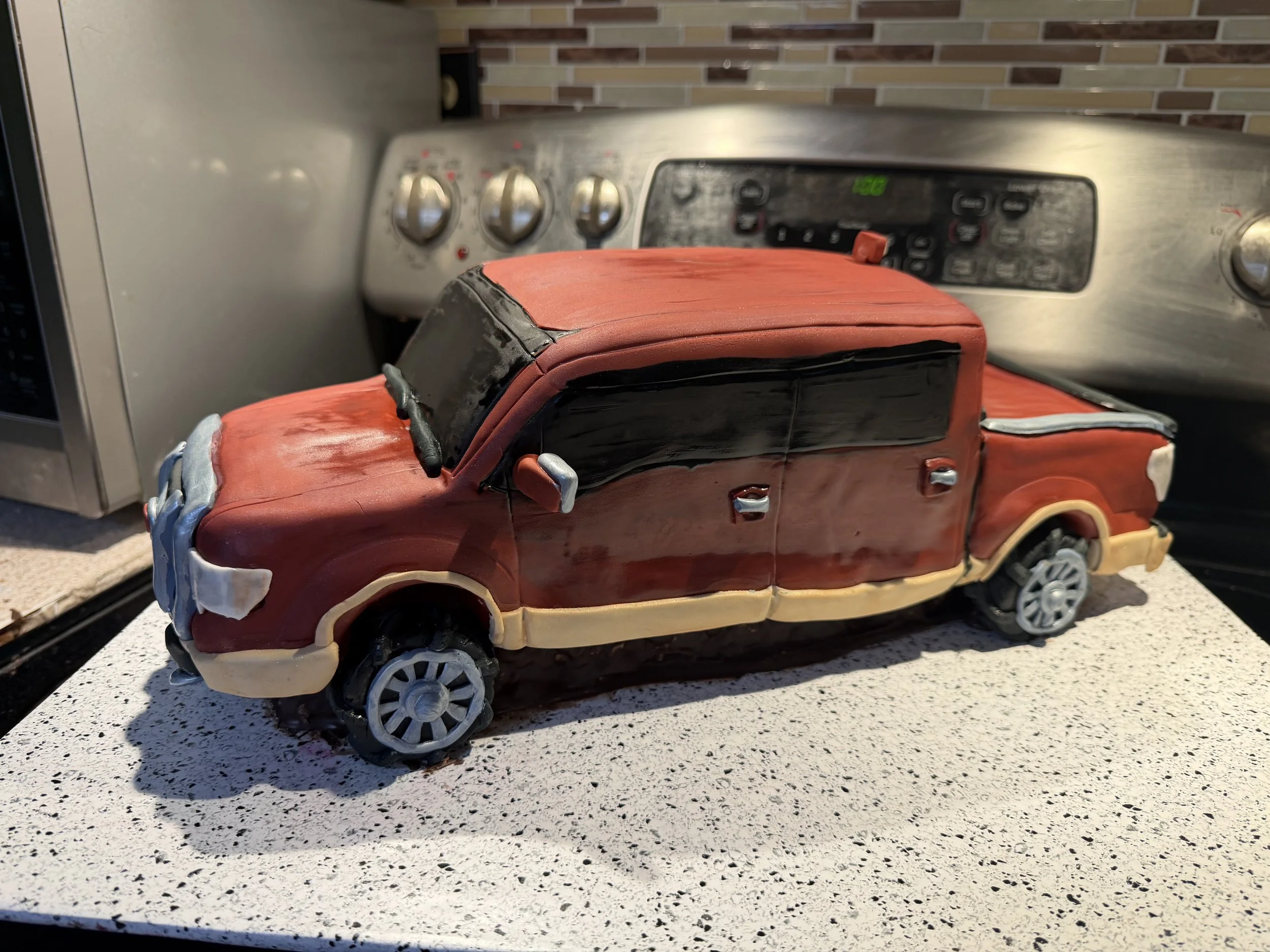 Designed to resemble a real pickup truck, this sculpted cake features hand-shaped body lines, custom wheels, metallic accents, and realistic proportions from every angle.
