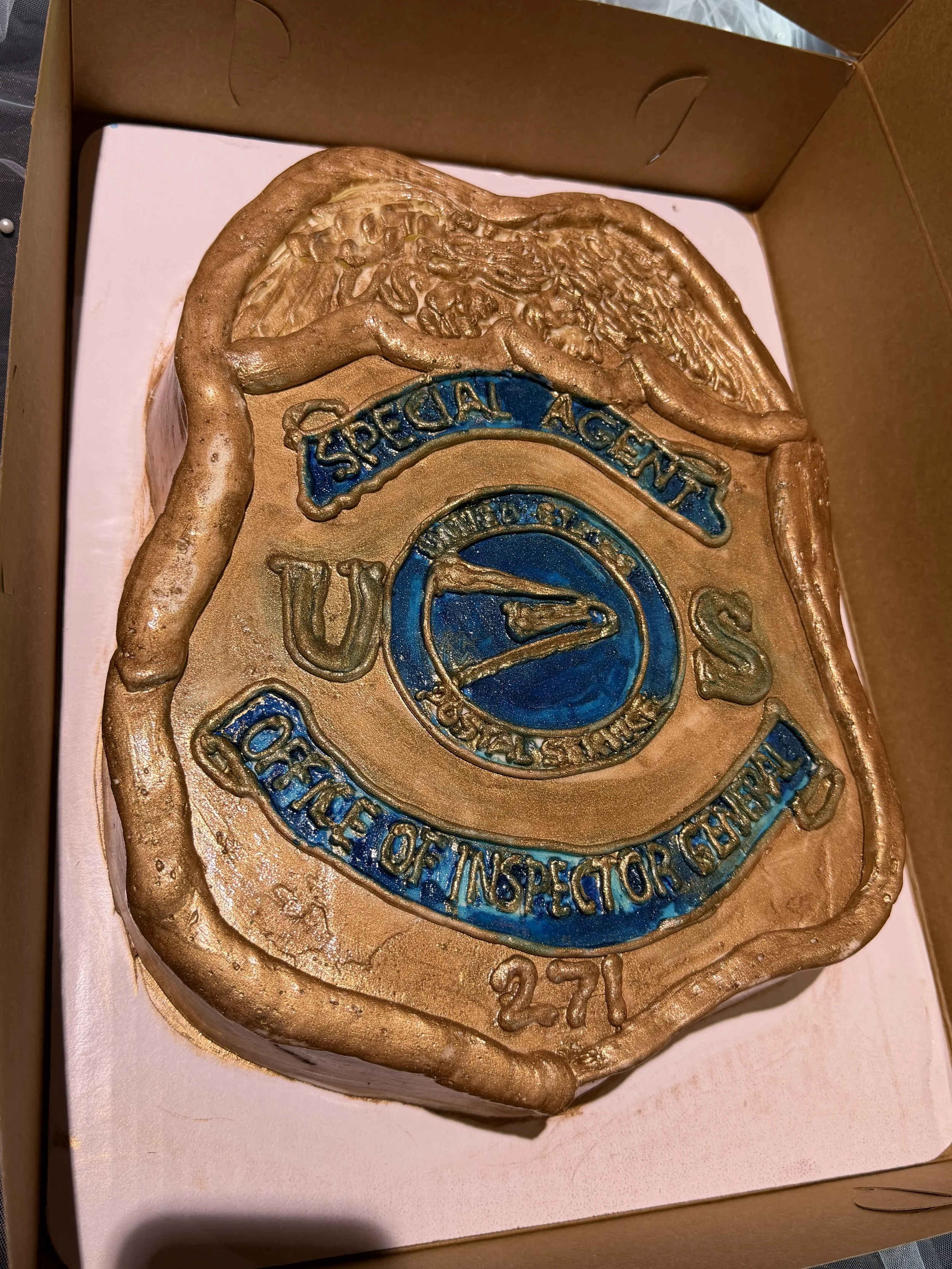 Retirement cake shaped and designed like the badge the employee carried 
