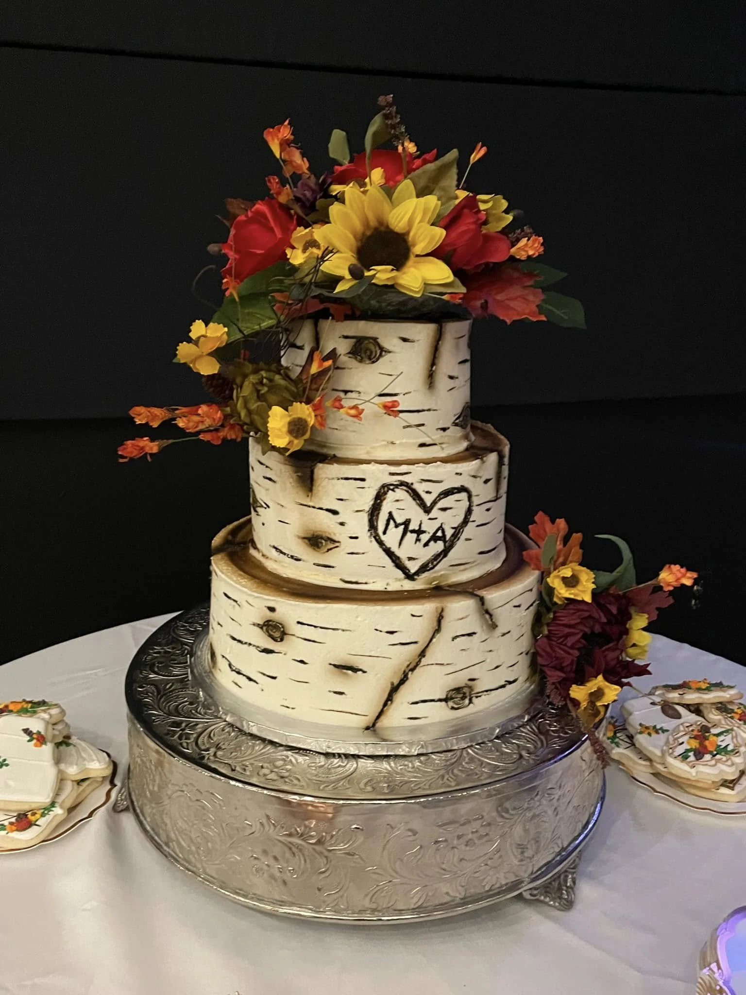 Rustic birch stump wedding cake with colorful sugar flowers in North Georgia