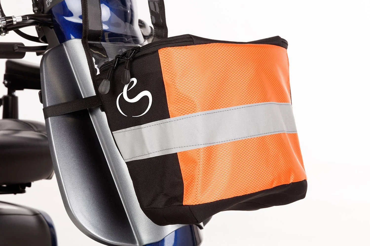 A mobility scooter's front basket cover with orange, gray, and black design, attached to the mobility scooter’s front basket.