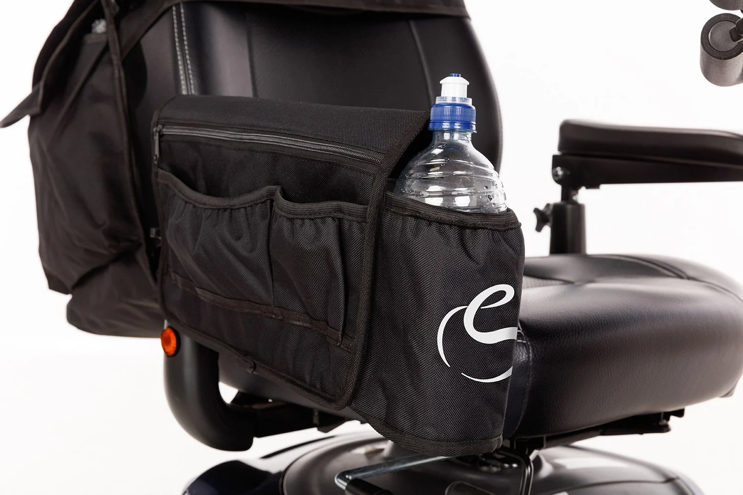 Close-up of a black armrest bag attached to the side of a mobility scooter, with a water bottle in its front drink bottle holder.