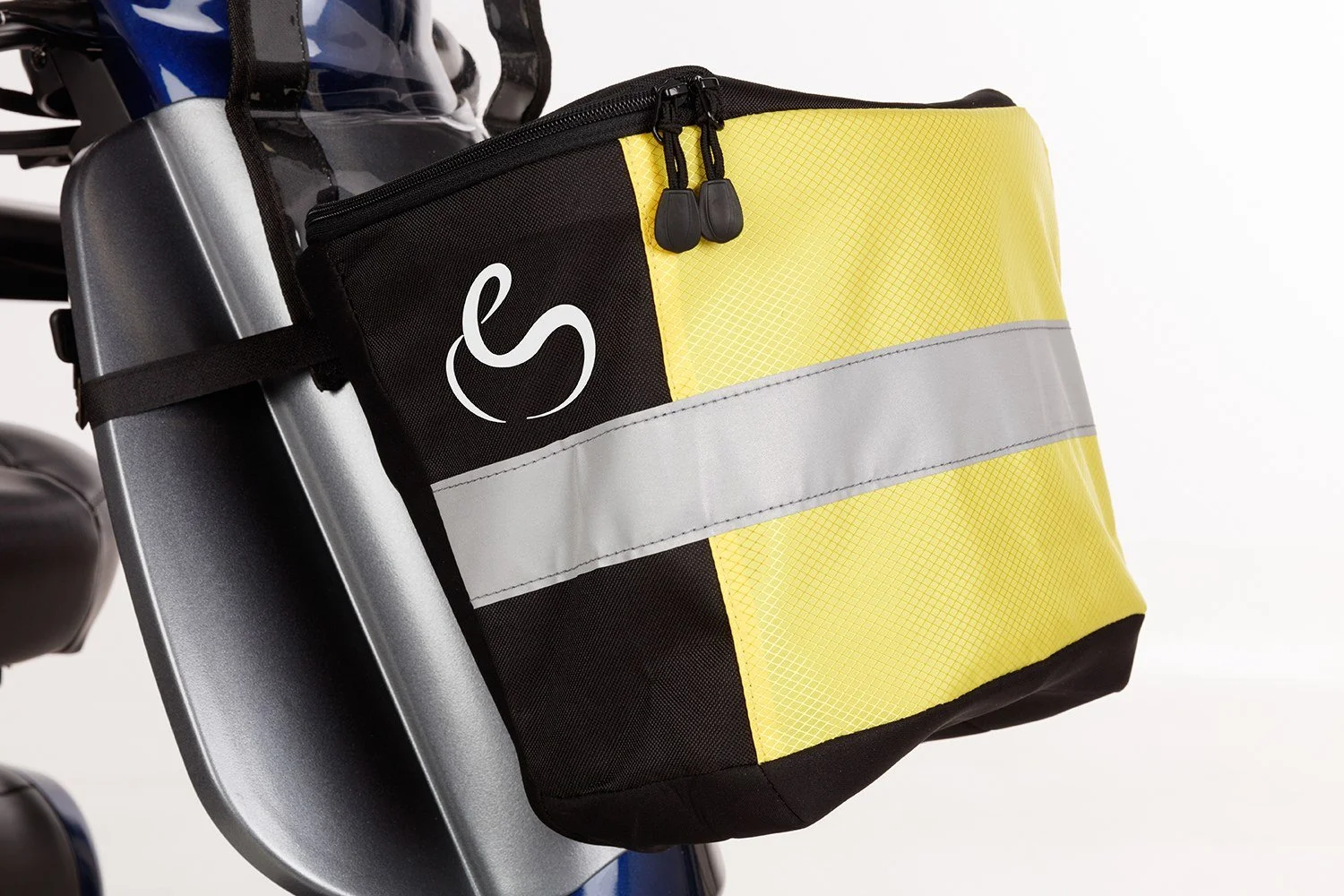 A yellow and black mobility scooter front basket with a grey reflective strip, attached to a mobility scooter.