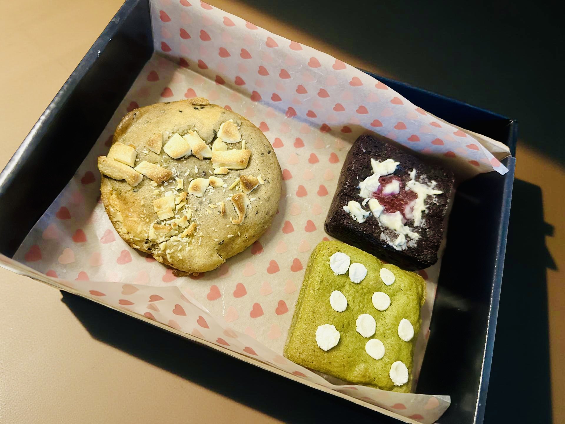 The Fusion Trio July Box featuring black sesame cookie, matcha blondie, and raspberry brownie showcasing East-meets-West dessert fusion in elegant black gift box