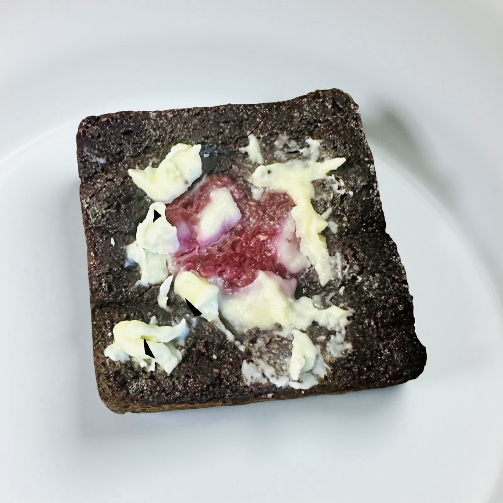 Thick raspberry white chocolate brownie bar showing rich chocolate base with fresh raspberry pieces and white chocolate chunks